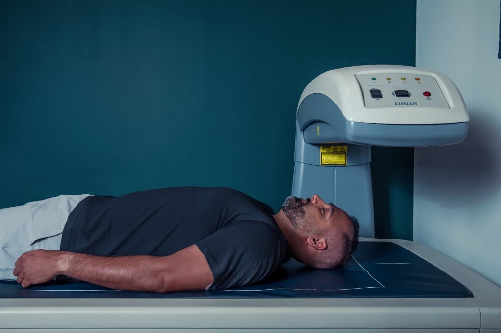 Member lying on a DEXA scanner during a body composition scan