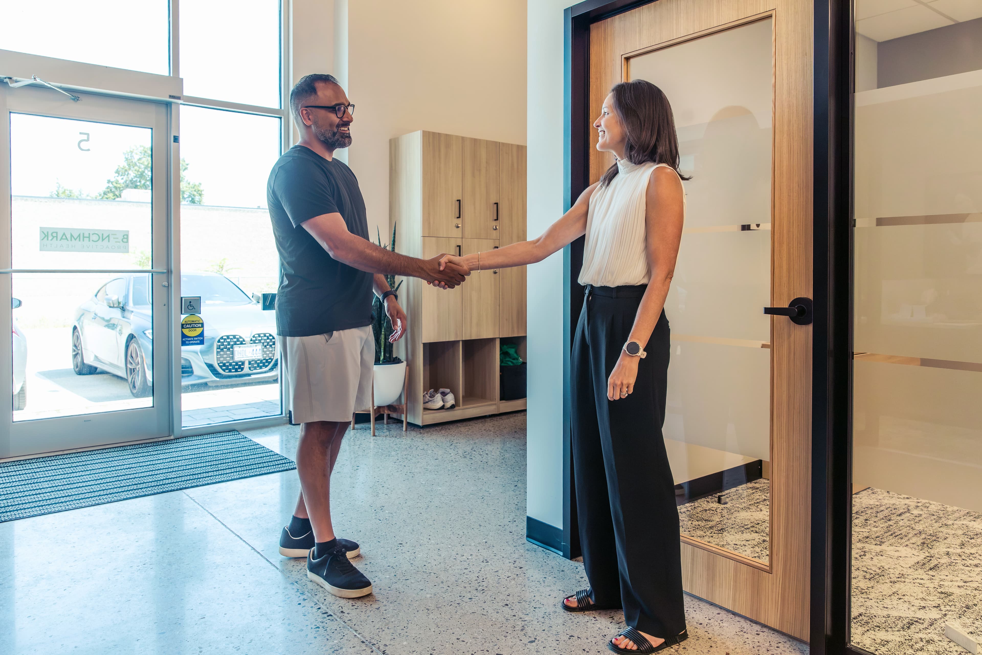 Benchmark team member greeting a visitor at the clinic entrance