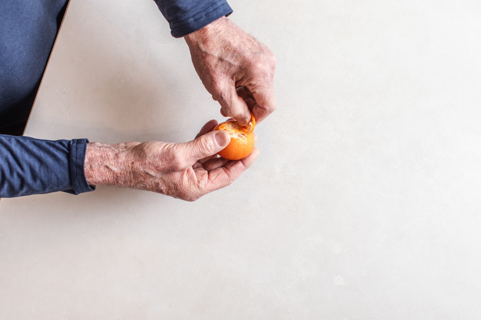 Person peeling an orange